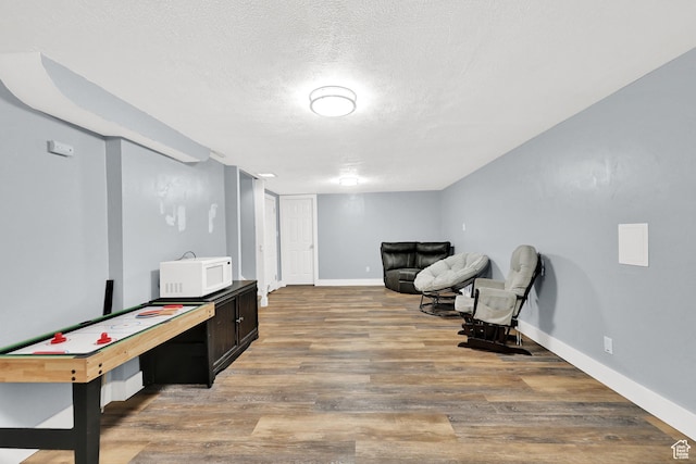 142 Green St, Layton, UT 84041 - recreation room featuring hardwood / wood-style floors and a textured ceiling