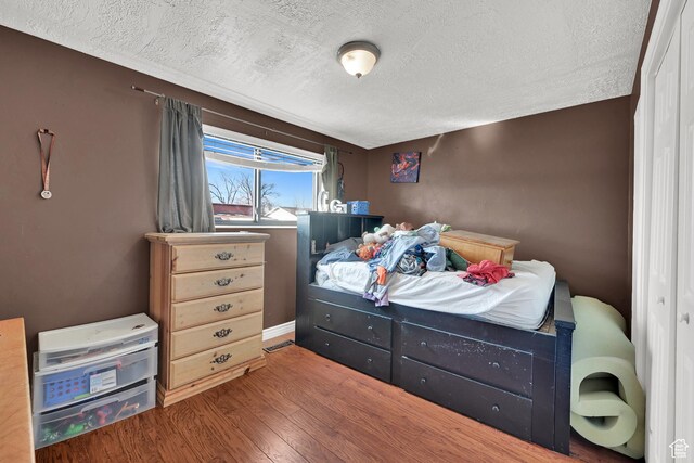 142 Green St, Layton, UT 84041 - bedroom with wood-type flooring and a textured ceiling