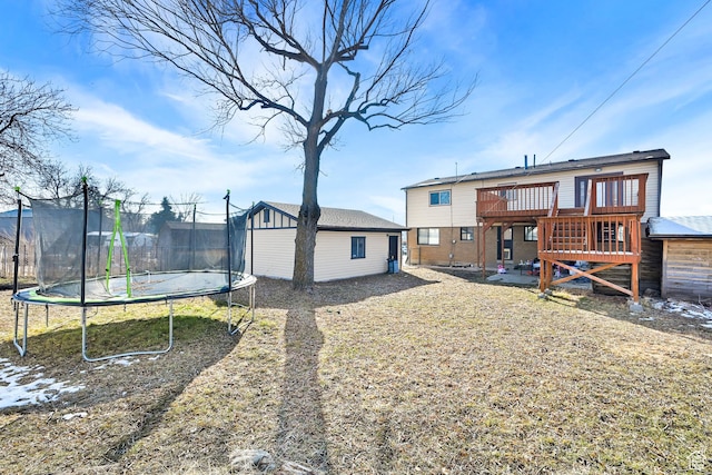 142 Green St, Layton, UT 84041 - rear view of house with a deck, a trampoline, and a shed