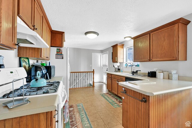 142 Green St, Layton, UT 84041 - kitchen featuring sink, a textured ceiling, light tile patterned floors, and gas range gas stove