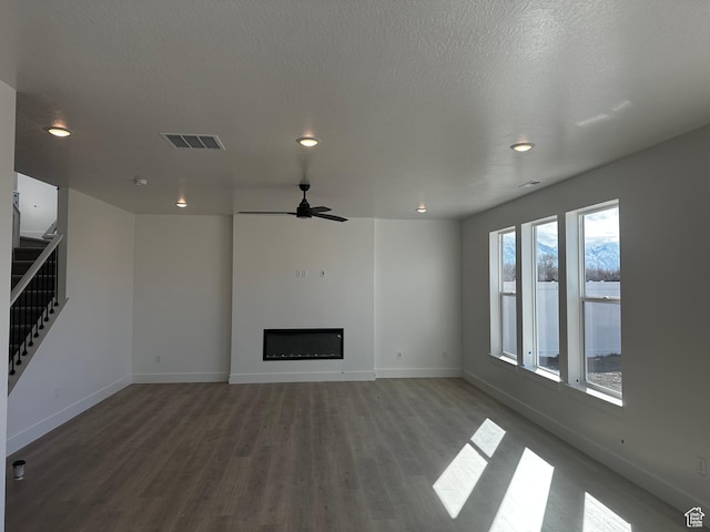595 W 330 S, American Fork, UT 84003 - unfurnished living room featuring visible vents, baseboards, stairs, a fireplace, and wood finished floors
