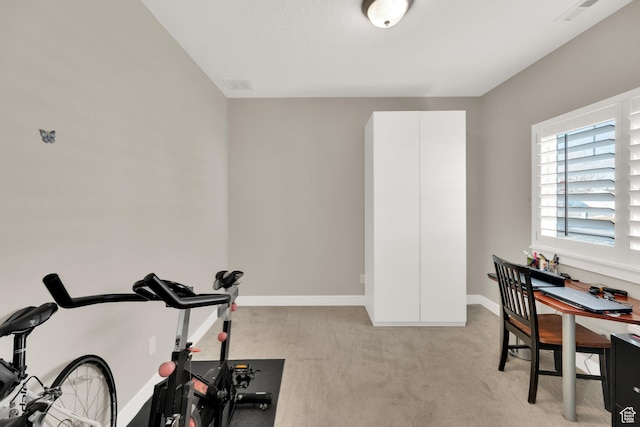 workout room with light colored carpet
