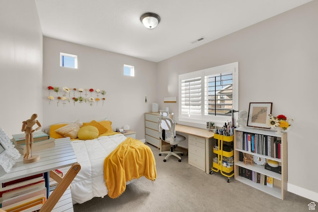bedroom featuring multiple windows and light colored carpet