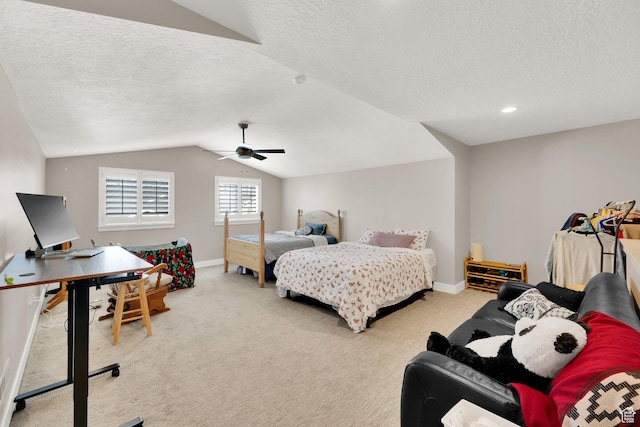 bedroom with ceiling fan, carpet, vaulted ceiling, and a textured ceiling