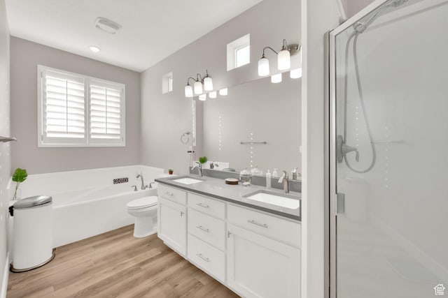 full bathroom with hardwood / wood-style floors, plenty of natural light, toilet, and shower with separate bathtub