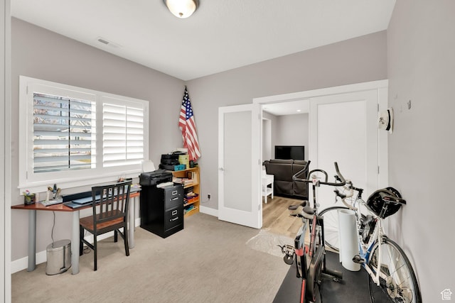 office area featuring light colored carpet
