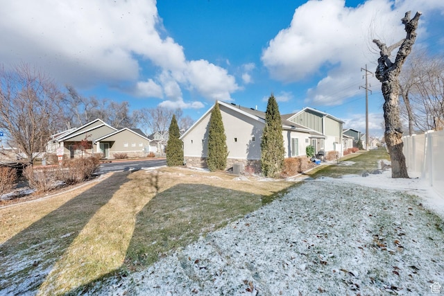 view of side of home featuring a yard