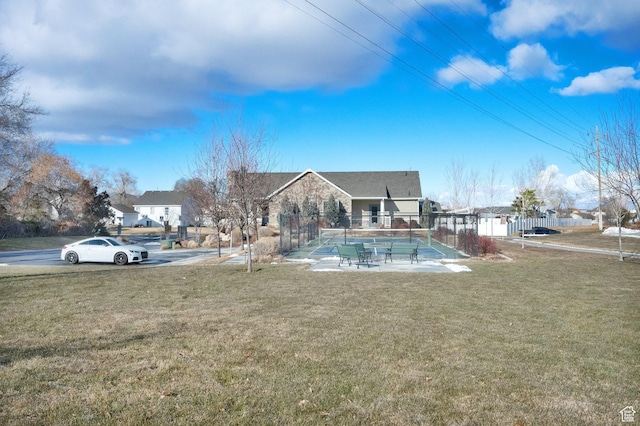 view of pool with a yard and tennis court