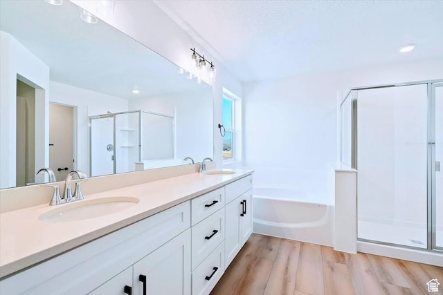 10009 N Dorado Way Unit 443, Highland, UT 84003 - bathroom featuring a shower stall, a garden tub, double vanity, wood finished floors, and recessed lighting