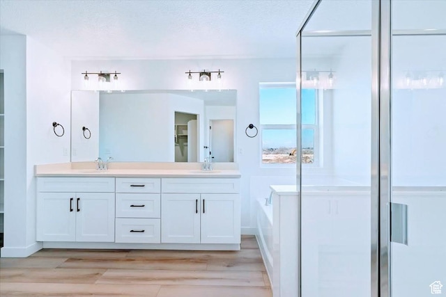 10009 N Dorado Way Unit 443, Highland, UT 84003 - full bath with a bath, double vanity, wood finished floors, and a shower stall