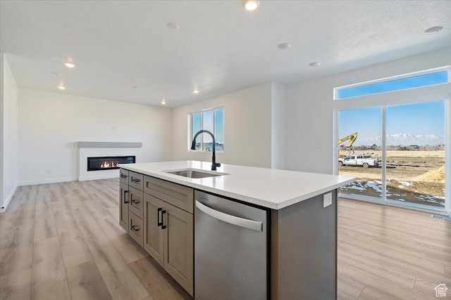 10009 N Dorado Way Unit 443, Highland, UT 84003 - kitchen featuring stainless steel dishwasher, a sink, gray cabinetry, light wood-style flooring, and light countertops