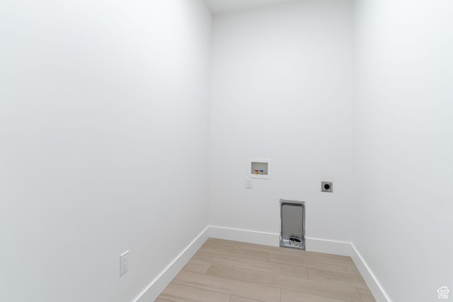 clothes washing area with laundry area, light wood-type flooring, hookup for a washing machine, baseboards, and electric dryer hookup