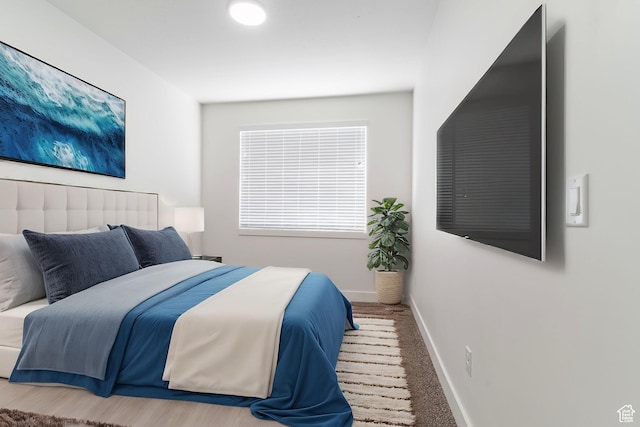 bedroom featuring baseboards and carpet