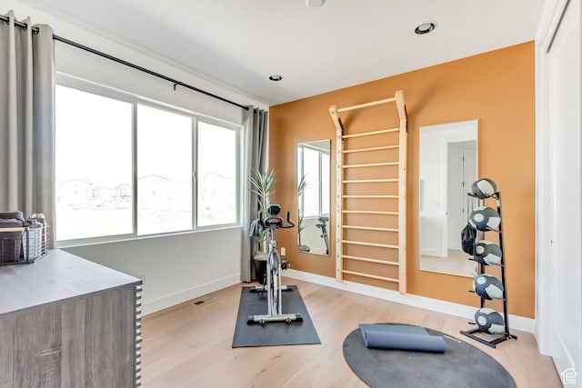 workout area with light wood-type flooring