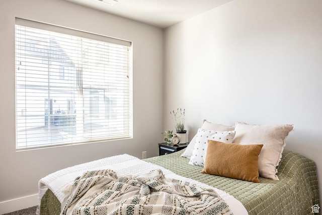bedroom featuring multiple windows and visible vents