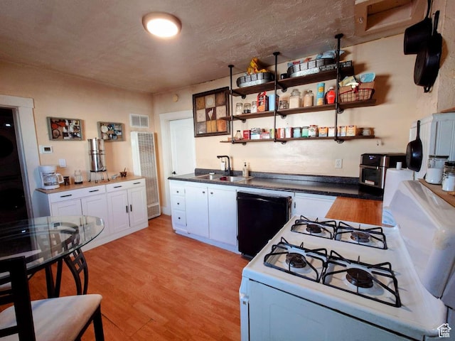 3260 Ogden Ave, Ogden, UT 84401 - kitchen with light hardwood / wood-style flooring, dishwasher, sink, white cabinets, and white gas stove