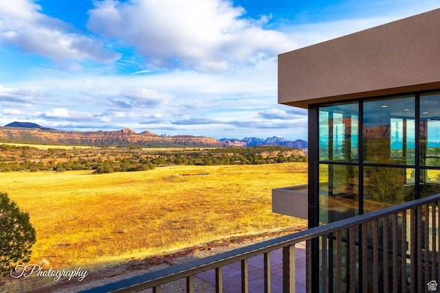 view of yard with a mountain view and a balcony