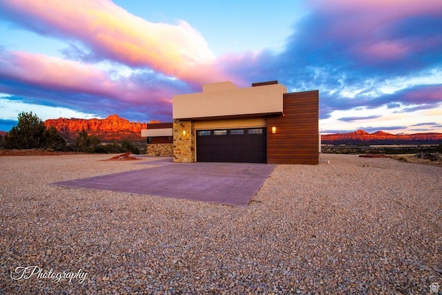 view of front facade with a mountain view and a garage