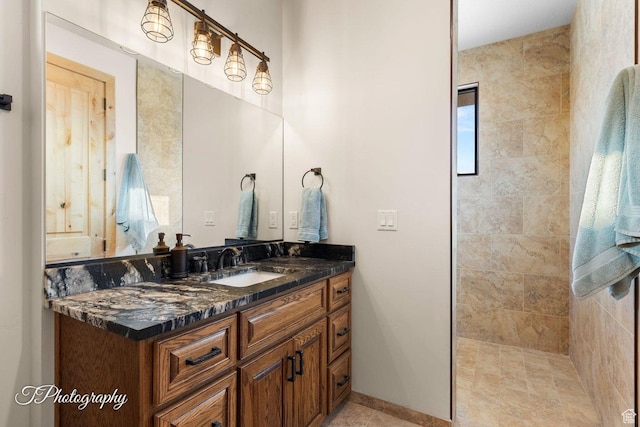 bathroom with vanity and a tile shower