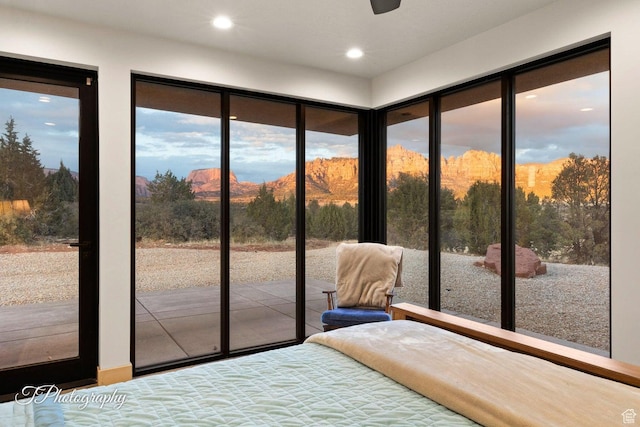 unfurnished bedroom featuring access to exterior and multiple windows