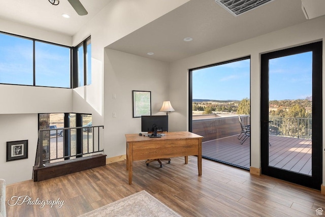 office area with a healthy amount of sunlight and hardwood / wood-style flooring