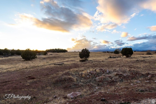nature at dusk featuring a rural view
