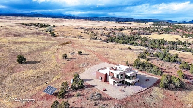 birds eye view of property with a mountain view