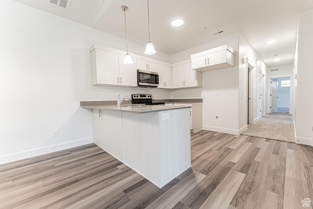 13742 S Hanley Ln Unit Gg303, Riverton, UT 84096 - kitchen featuring stainless steel microwave, a peninsula, light wood-style flooring, range with electric stovetop, and decorative light fixtures