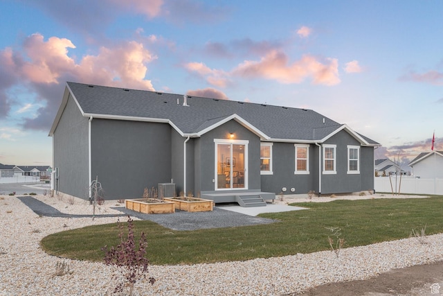 537 W Coyote Ridge Rd, Grantsville, UT 84029 - back house at dusk with a lawn