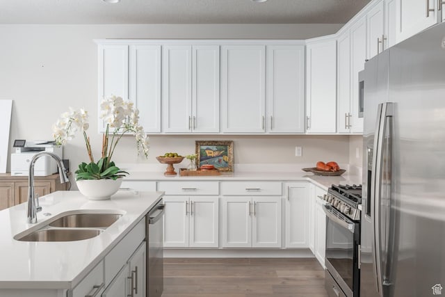 537 W Coyote Ridge Rd, Grantsville, UT 84029 - kitchen featuring sink, white cabinetry, and stainless steel appliances