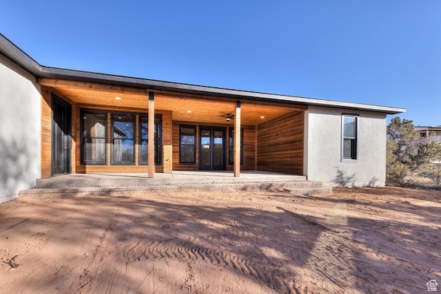 view of exterior entry with a patio area