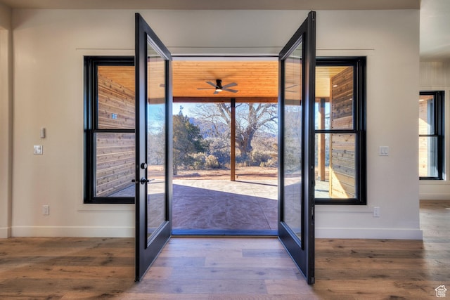 doorway to outside with hardwood / wood-style flooring, ceiling fan, and french doors