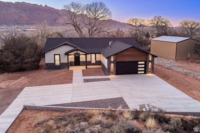 view of front of home with a mountain view and a garage