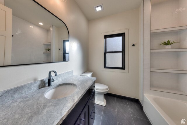 bathroom featuring tile patterned floors, toilet, and vanity