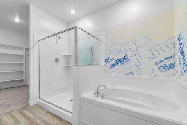 727 W Cherry Unit 214, Grantsville, UT 84029 - full bathroom featuring a stall shower, a garden tub, and wood finished floors