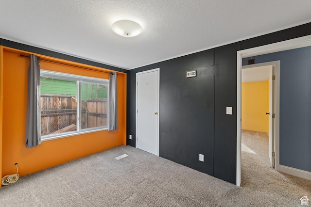 112 Arbor Dr, Moab, UT 84532 - unfurnished bedroom featuring a closet, a textured ceiling, and carpet floors