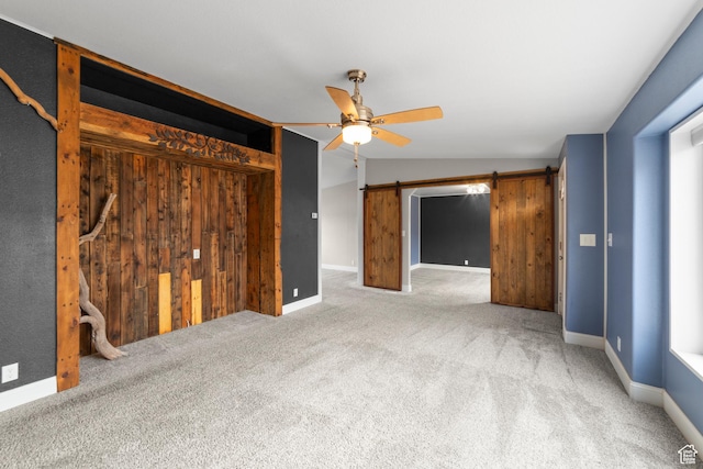 112 Arbor Dr, Moab, UT 84532 - unfurnished bedroom featuring lofted ceiling, carpet floors, ceiling fan, and a barn door