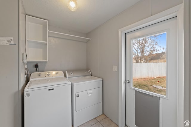 112 Arbor Dr, Moab, UT 84532 - clothes washing area featuring light tile patterned flooring, a textured ceiling, and washer and dryer