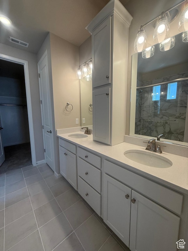 6158 W 11800 S Unit 504, South Jordan, UT 84009 - bathroom with tile patterned flooring, a marble finish shower, double vanity, and a closet