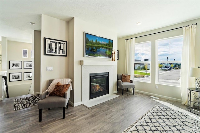 6158 W 11800 S Unit 504, South Jordan, UT 84009 - sitting room with wood finished floors, a high end fireplace, a textured ceiling, and recessed lighting