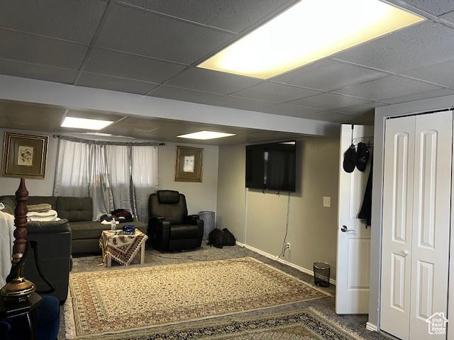 interior space featuring carpet floors and a paneled ceiling