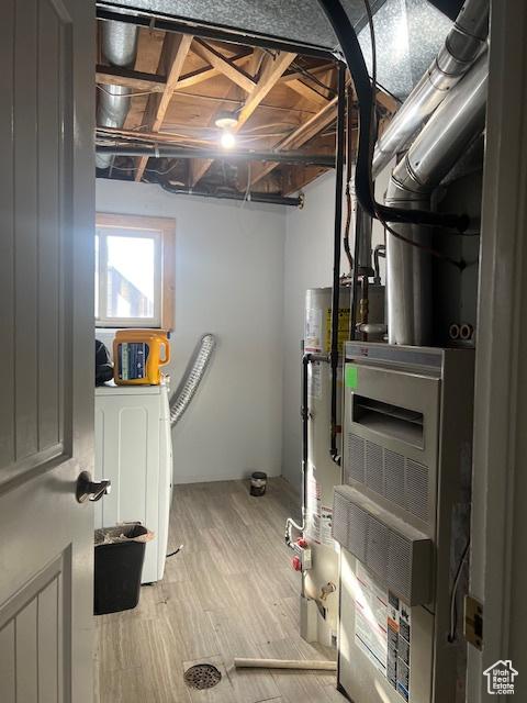 interior space featuring light wood-type flooring, washer / clothes dryer, and water heater