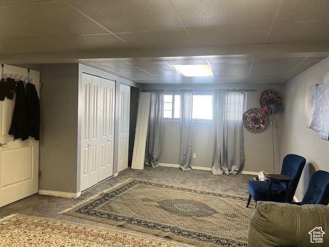 sitting room featuring carpet flooring and a paneled ceiling