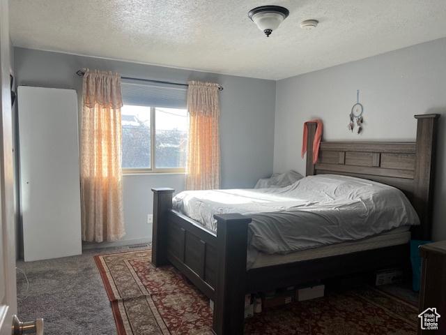 carpeted bedroom featuring a textured ceiling