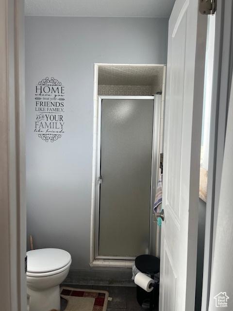 bathroom featuring toilet and walk in shower