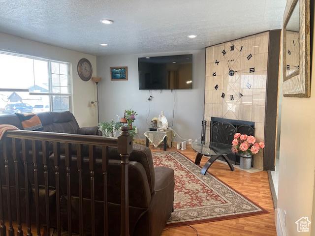 living room with hardwood / wood-style floors and a textured ceiling