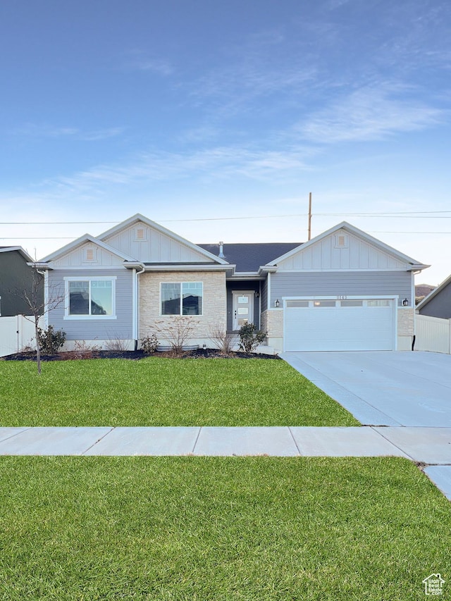 ranch-style home with a garage, a front yard, brick siding, and driveway