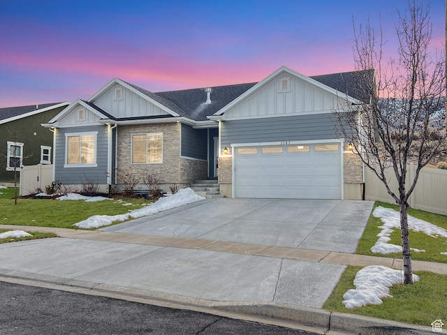 craftsman-style house featuring concrete driveway, an attached garage, board and batten siding, a front yard, and stone siding