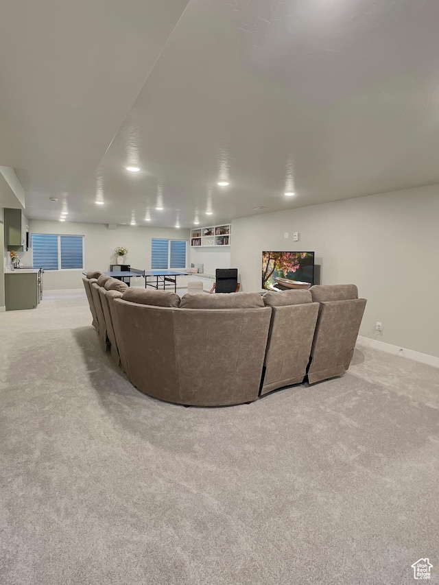 living room featuring light carpet and baseboards