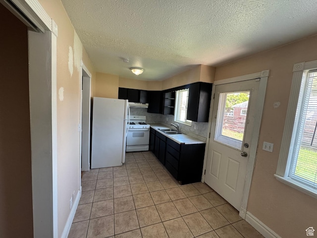 3375 S Meadowlark Dr, West Valley City, UT 84119 - kitchen featuring white appliances, a sink, dark cabinets, a textured ceiling, and light countertops